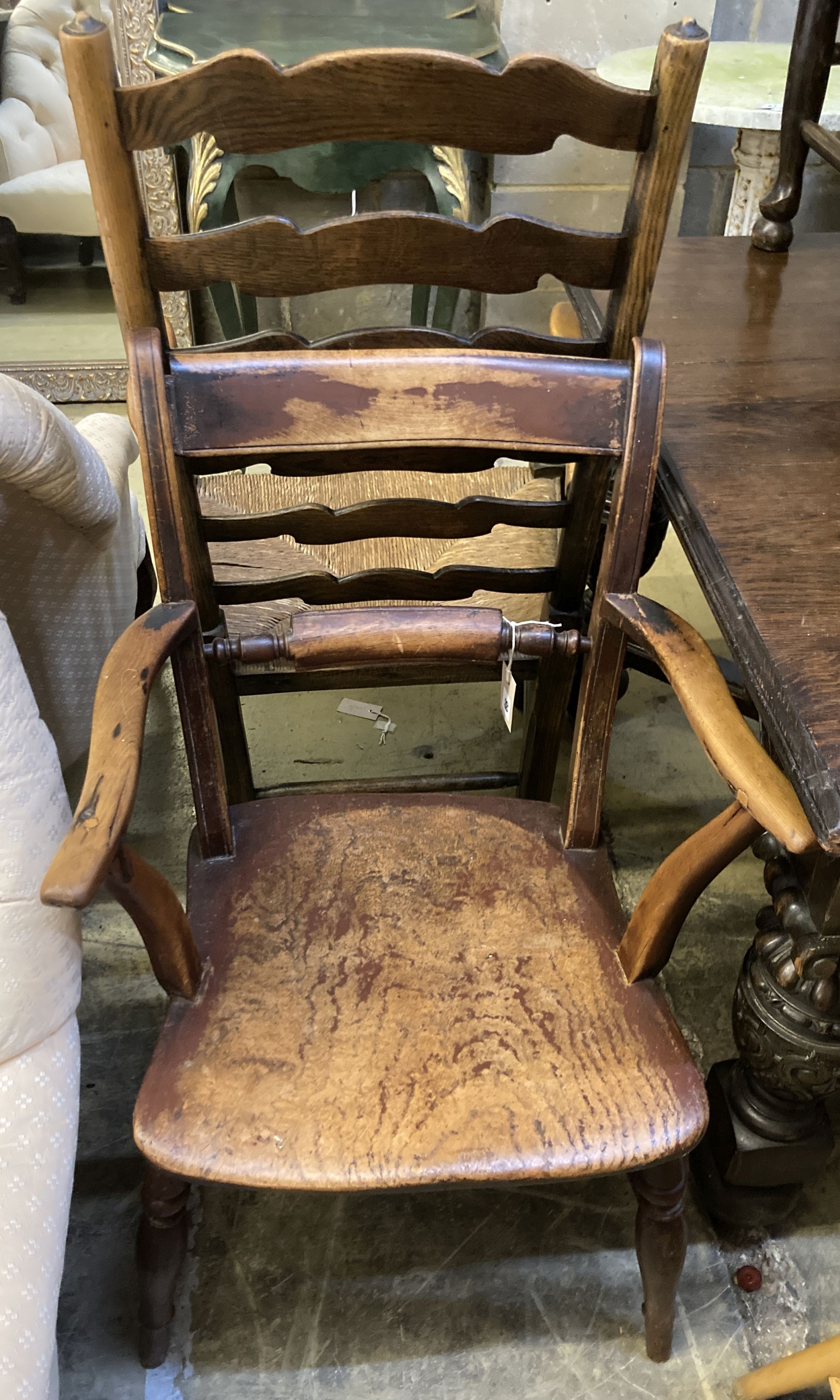 A 19th century ash and beech ladderback elbow chair and a spindle back elbow chair (2)